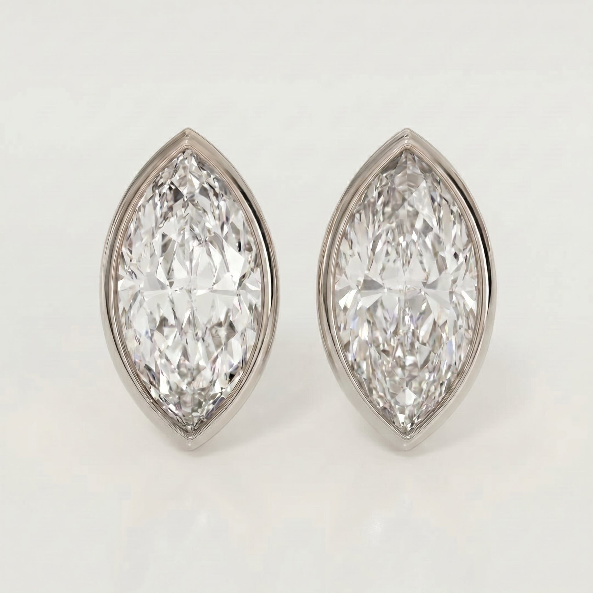 Pair of diamond earrings on a light gray background