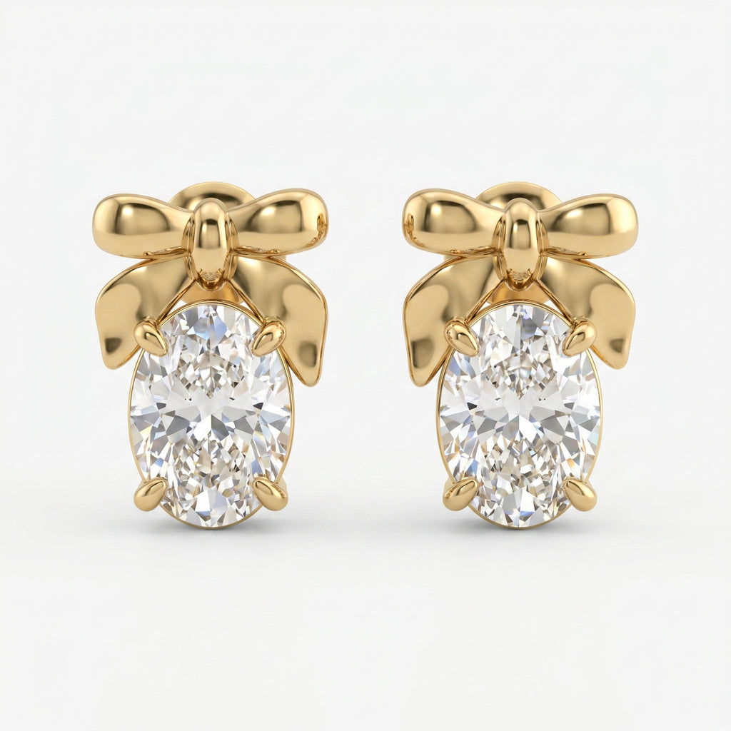 Luxury yellow gold bow stud earrings with oval-cut diamond stones on a clean white background