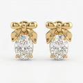 Luxury yellow gold bow stud earrings with oval-cut diamond stones on a clean white background