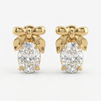 Luxury yellow gold bow stud earrings with oval-cut diamond stones on a clean white background