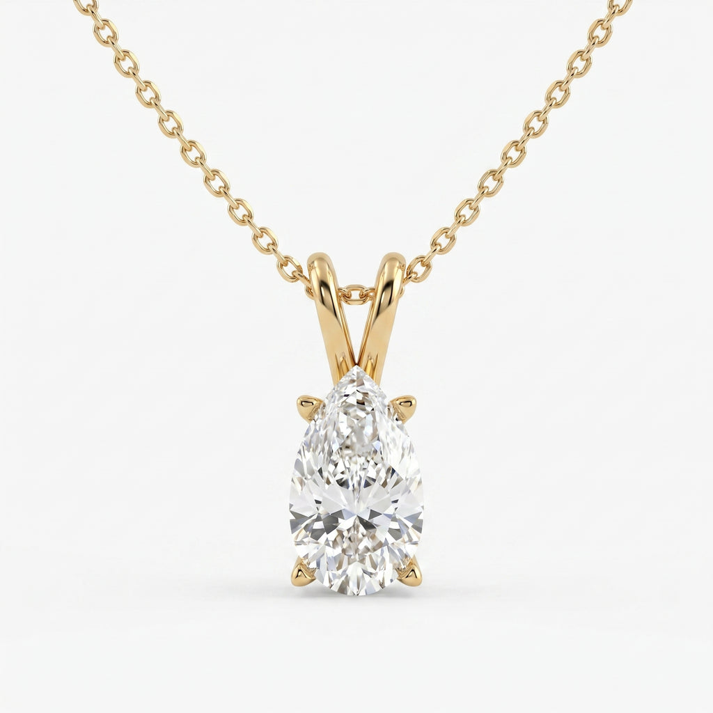 Gold necklace with a pear-shaped diamond pendant on a white background