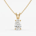 Gold necklace with a pear-shaped diamond pendant on a white background