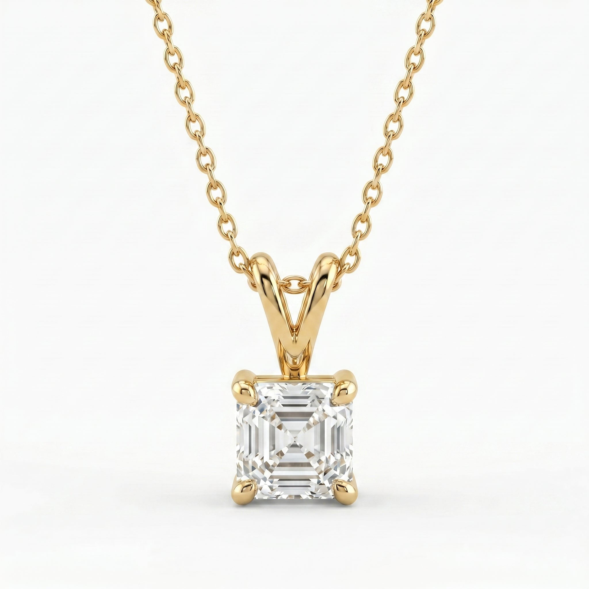 Gold necklace with a diamond pendant on a white background