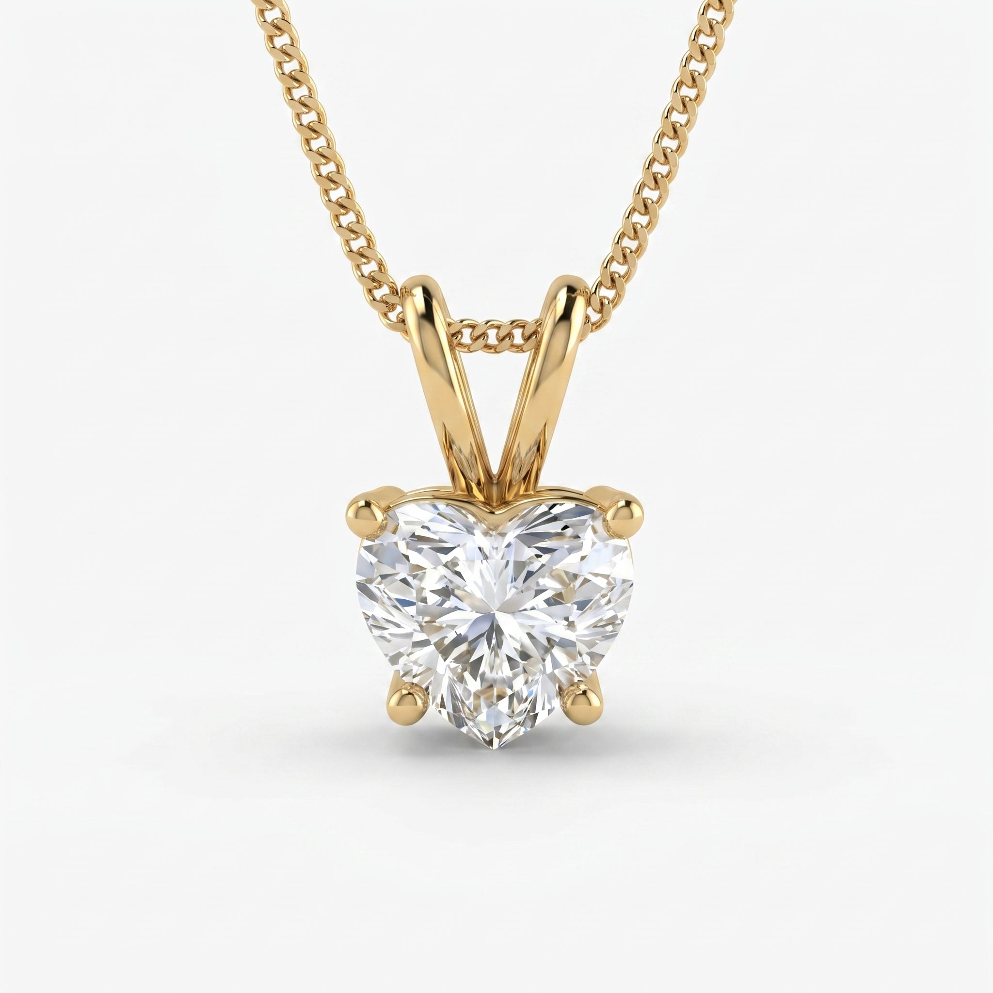 Gold necklace with a heart-shaped diamond pendant on a white background