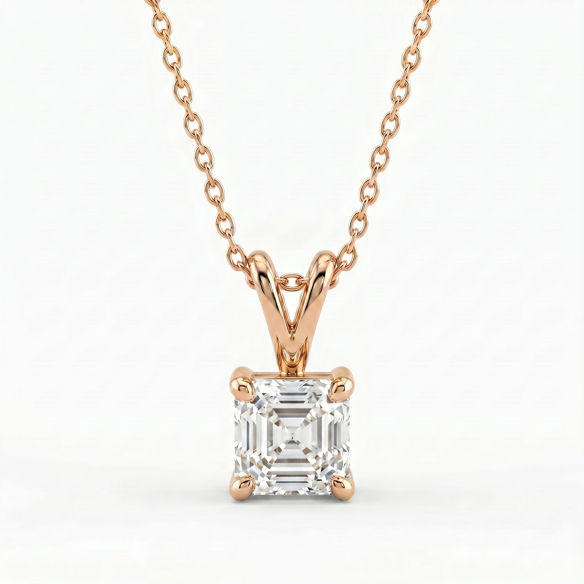 Rose gold necklace with a diamond pendant on a white background