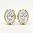 Oval bezel-set diamond stud earrings in polished yellow gold with brilliant sparkle on clean white background