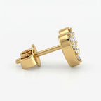 Side profile of yellow gold heart diamond earrings showing secure prong setting and polished finish