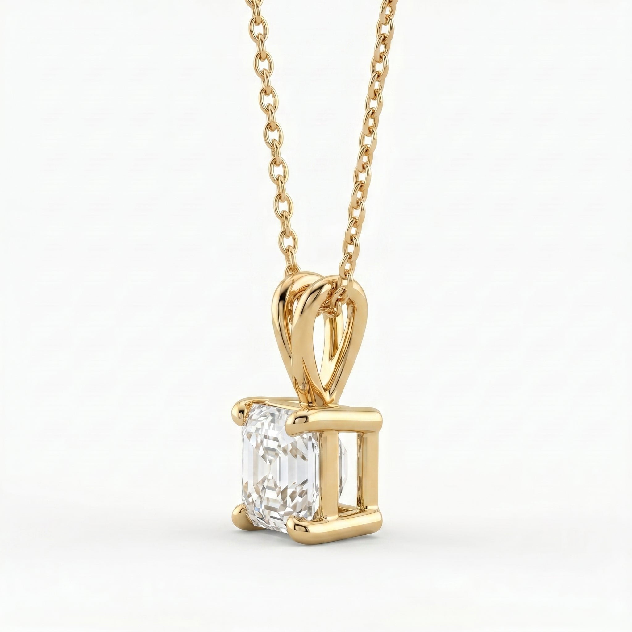 Gold pendant with a diamond on a white background