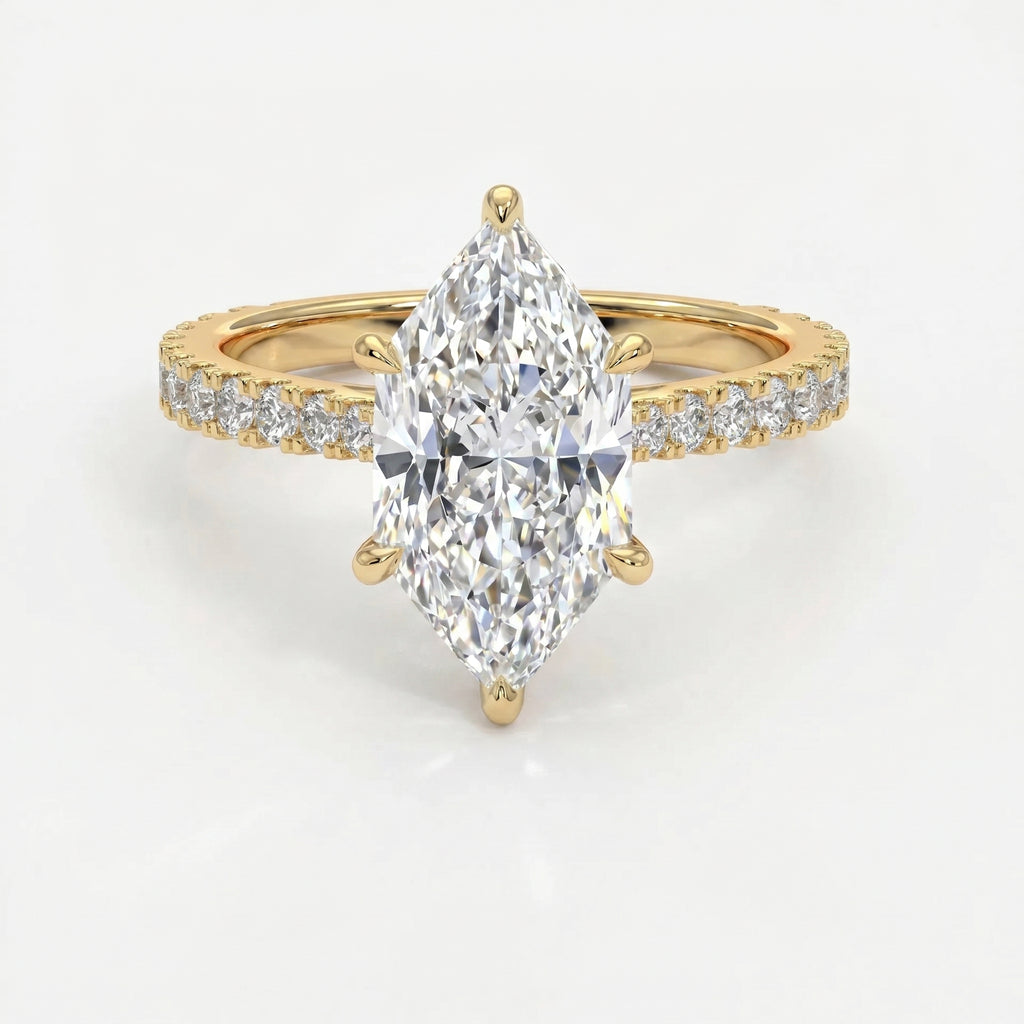 Marquise cut diamond engagement ring in yellow gold with pavé diamond band and secure six-prong setting.