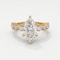 Marquise diamond engagement ring in yellow gold with pavé and marquise accent diamonds on a luxury bridal band