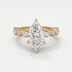 Marquise diamond engagement ring in yellow gold with pavé and marquise accent diamonds on a luxury bridal band