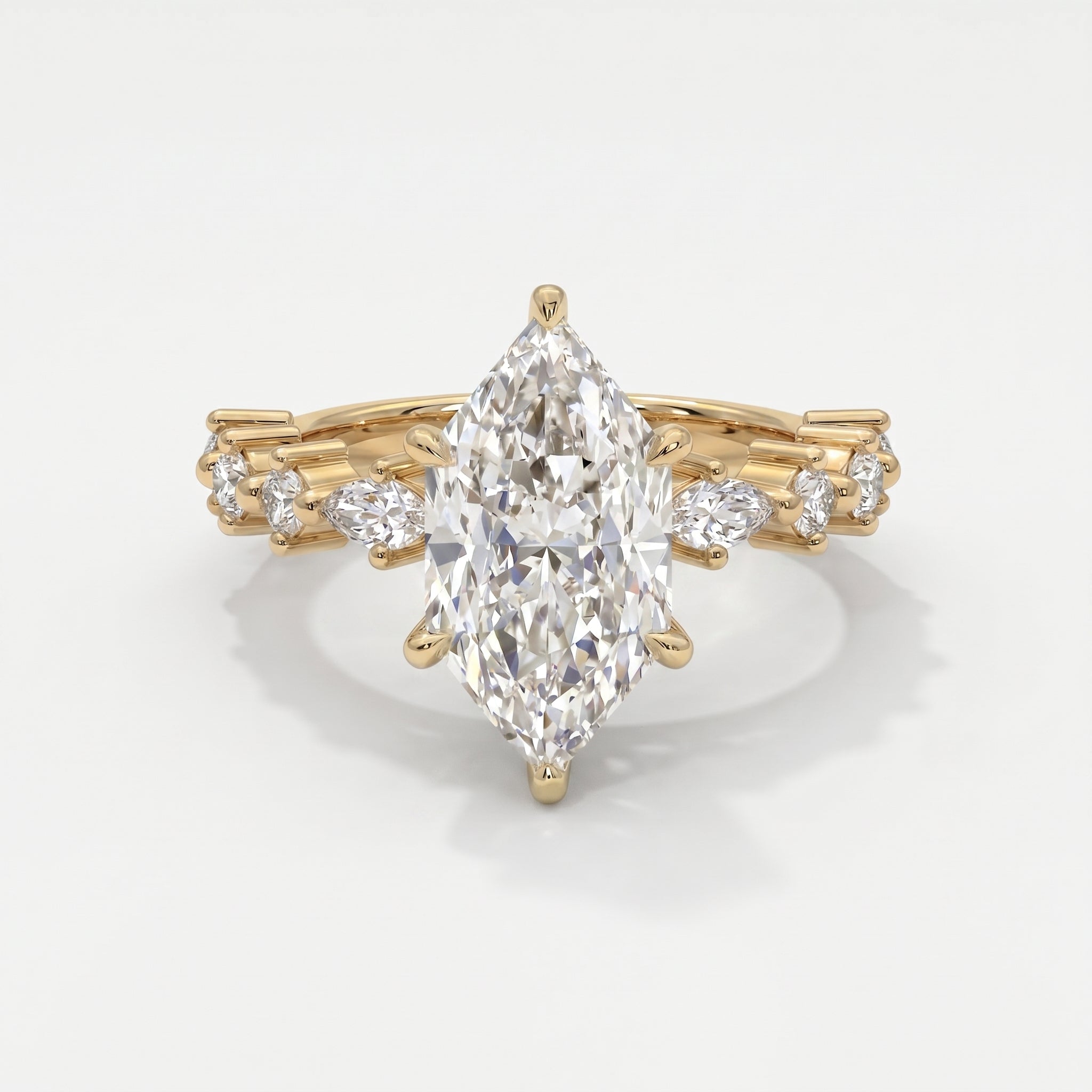 Marquise diamond engagement ring in yellow gold with pavé and marquise accent diamonds on a luxury bridal band