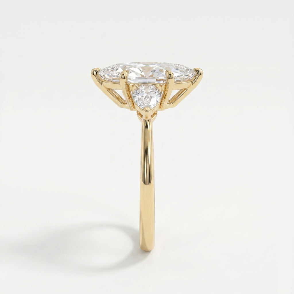 Side profile of marquise diamond engagement ring showing cathedral setting and pear accent diamonds