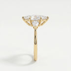 Side profile of marquise diamond engagement ring showing cathedral setting and pear accent diamonds