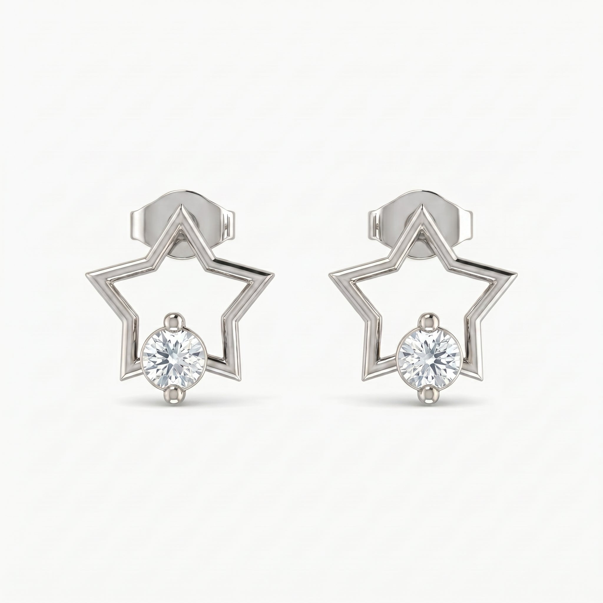 Angled view of White gold star earrings with sparkling crystal detail and polished minimalist geometric design