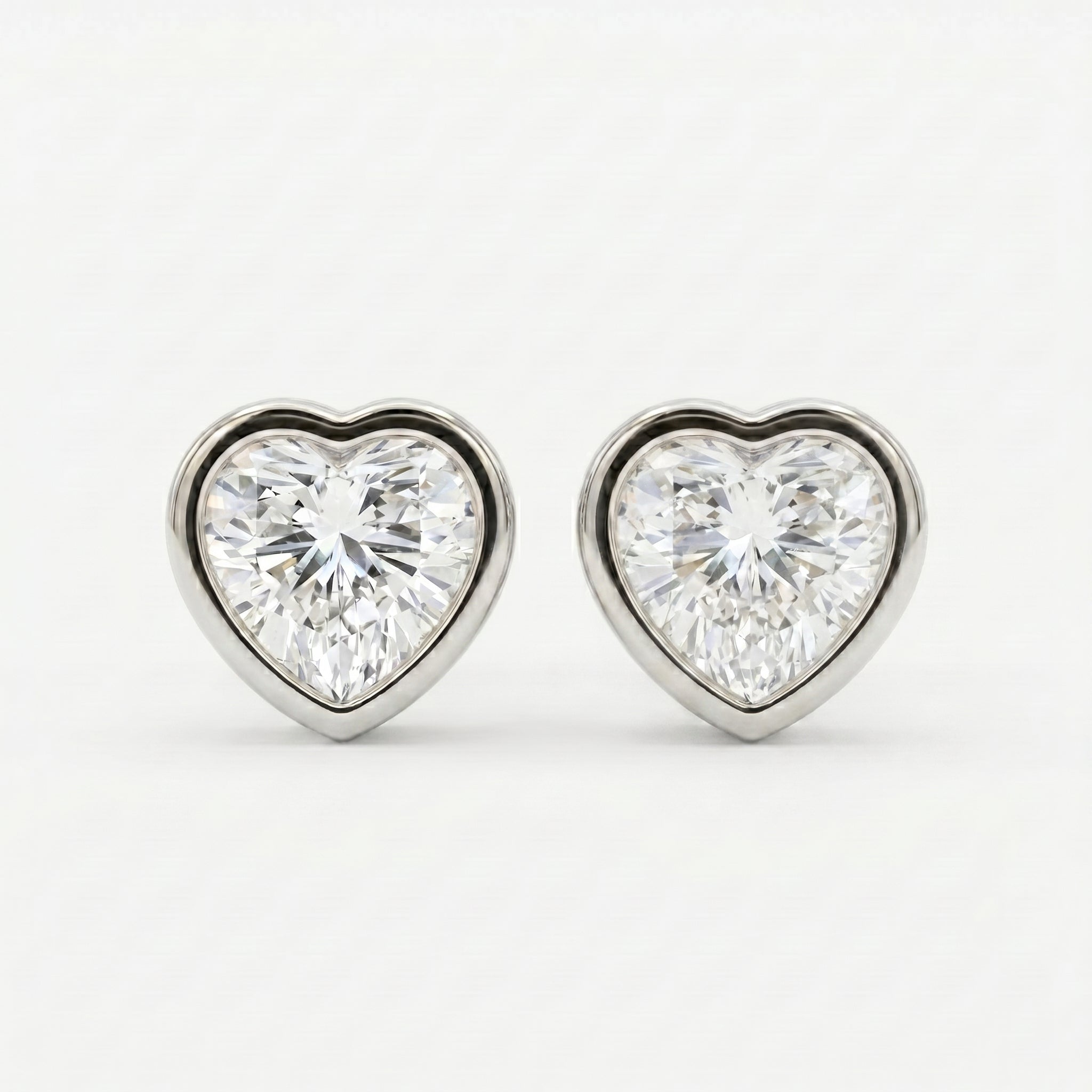 Heart-shaped diamond earrings on a white background