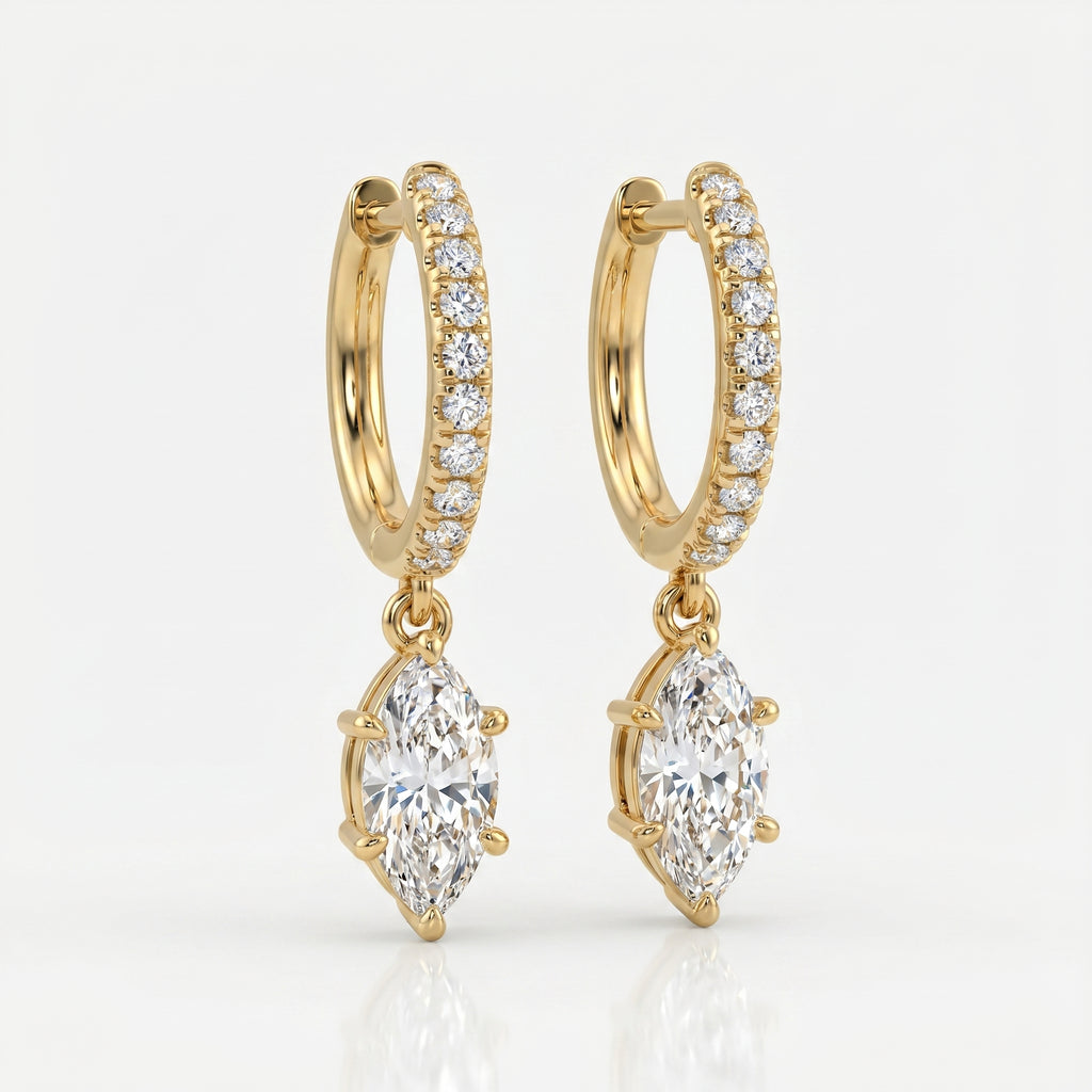 Luxury yellow gold hoop earrings with dangling marquise diamonds photographed at elegant 45-degree angle