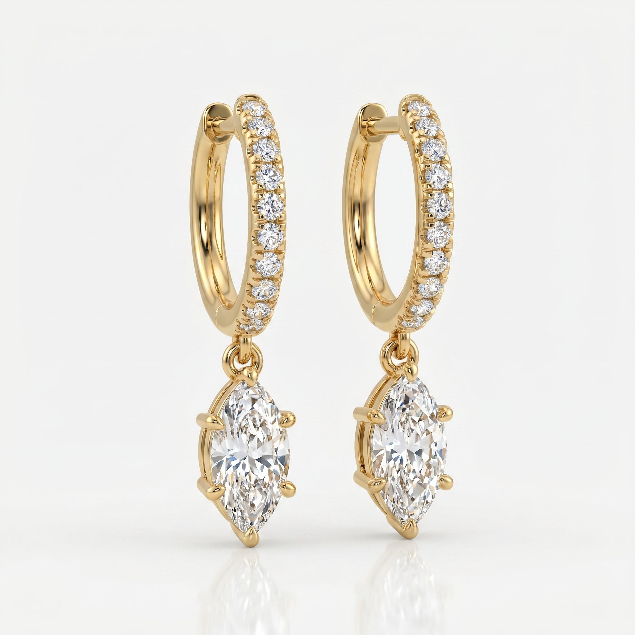 Luxury yellow gold hoop earrings with dangling marquise diamonds photographed at elegant 45-degree angle