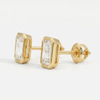 Gold earrings with emerald-cut diamonds on a white background