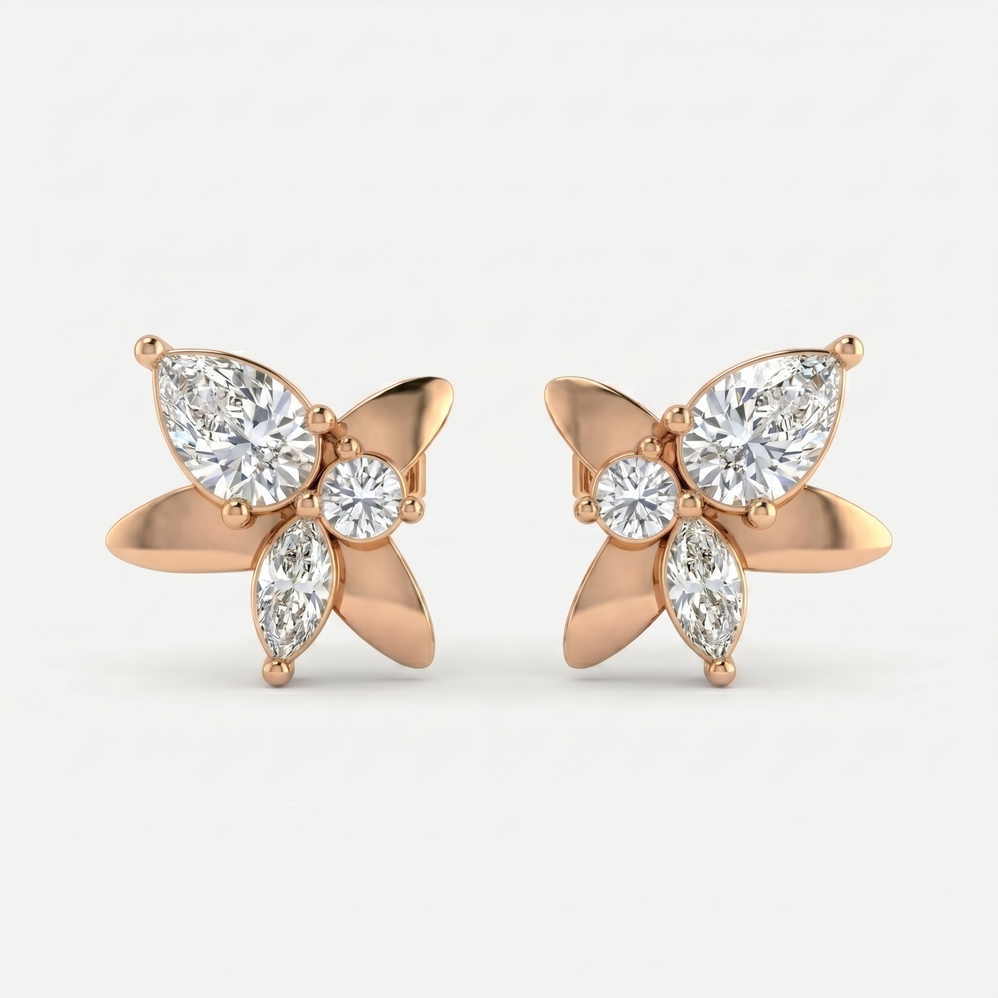 Premium butterfly stud earrings with sparkling pear cut diamonds in polished yellow gold angled view