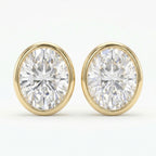 Pair of diamond stud earrings with gold rims on a white background