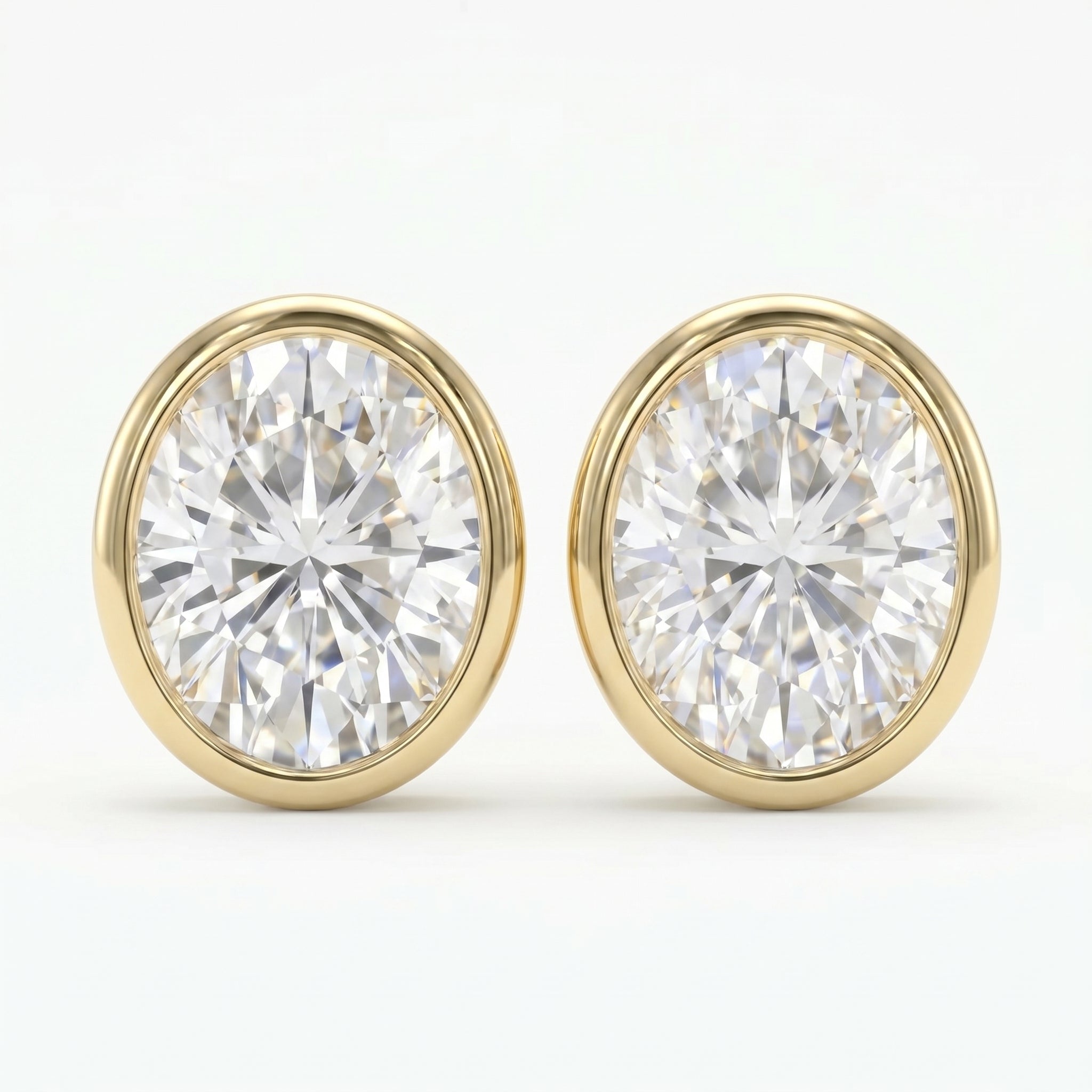 Pair of diamond stud earrings with gold rims on a white background