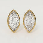 Pair of diamond earrings with gold settings on a light gray background