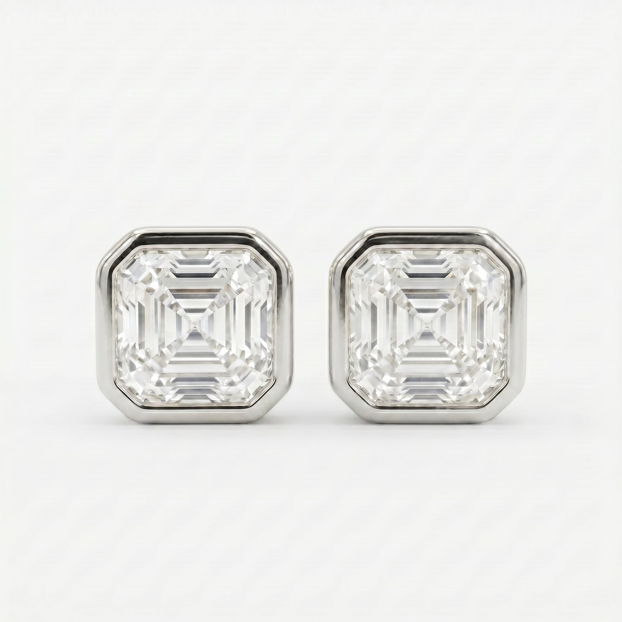 Pair of diamond stud earrings on a white background