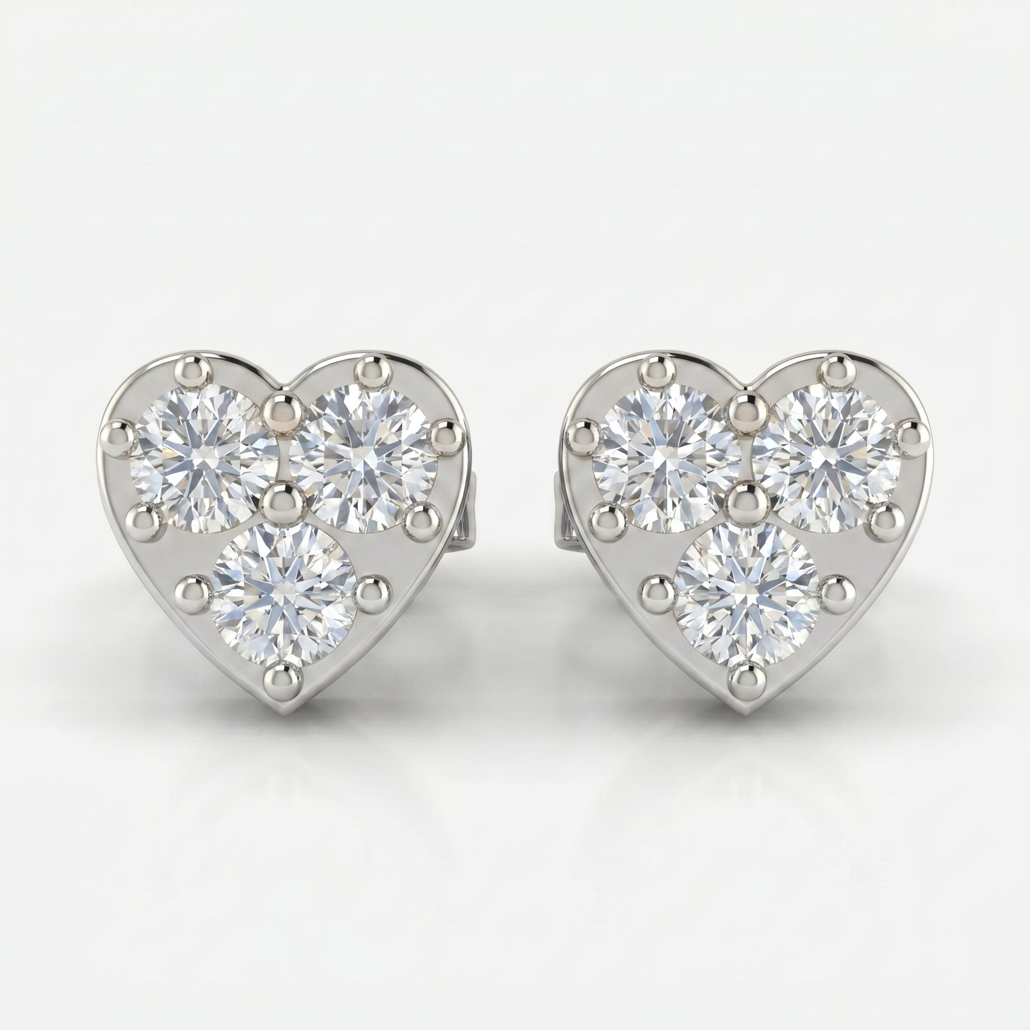 45 degree view of rose gold heart stud earrings featuring round brilliant diamond cluster design