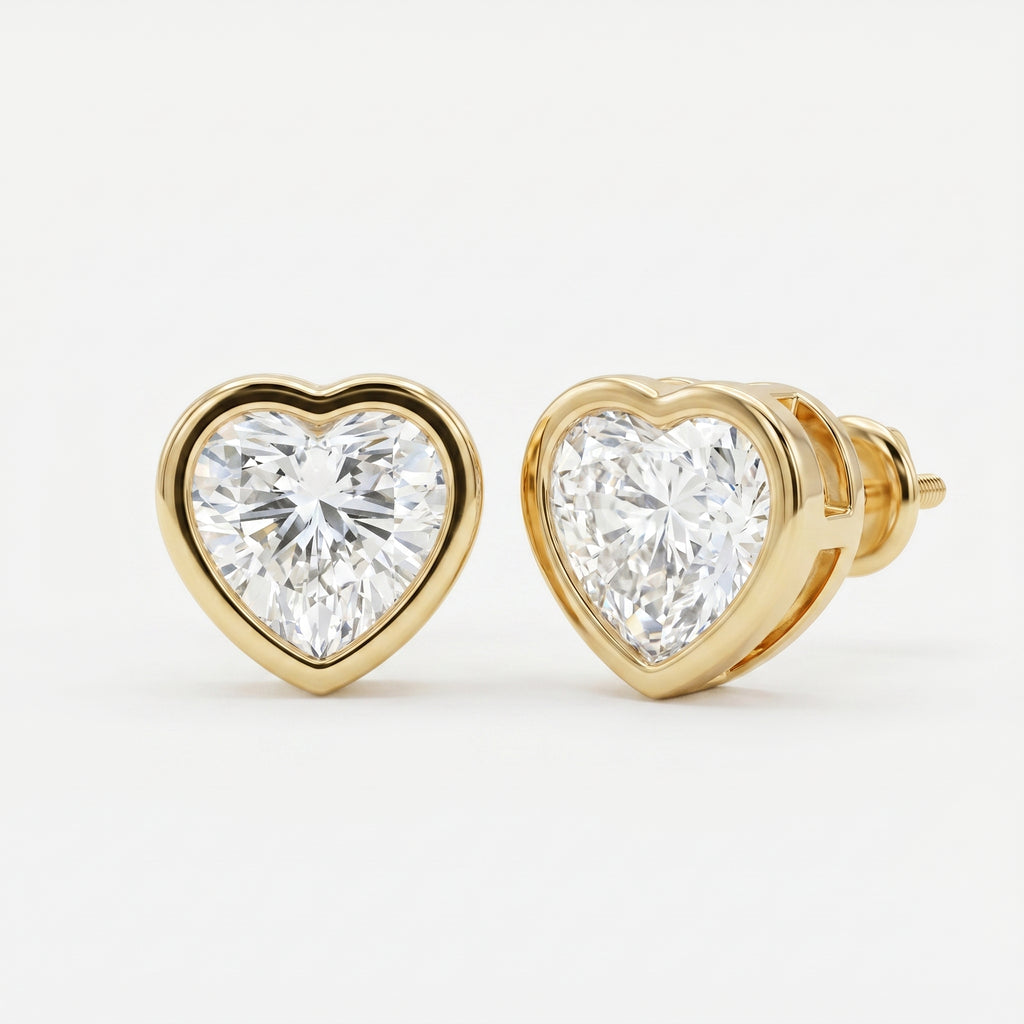 Heart-shaped diamond earrings with gold setting on a white background