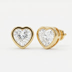 Heart-shaped diamond earrings with gold setting on a white background