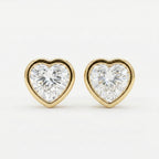 Heart-shaped diamond earrings with gold settings on a white background