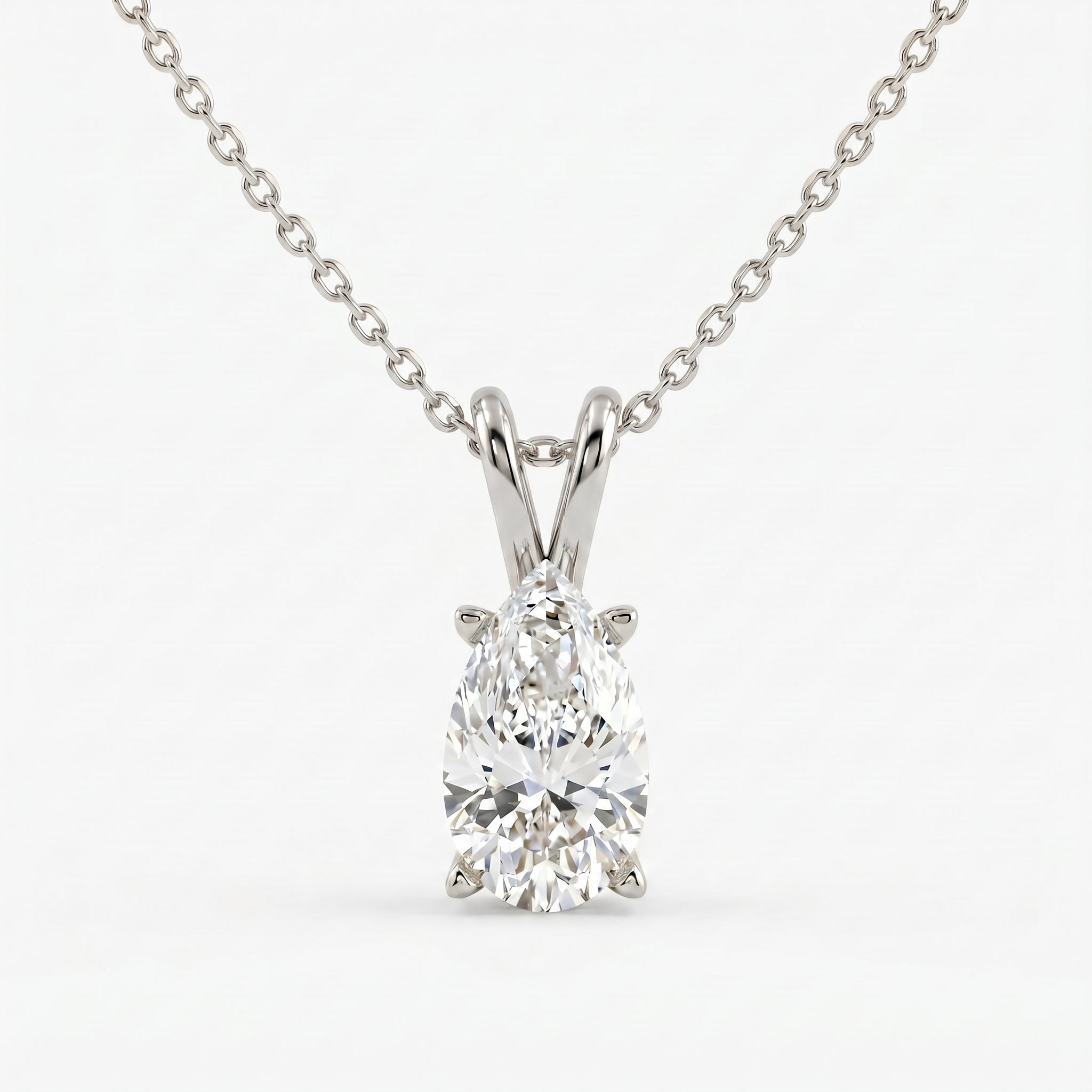 Diamond pendant on a chain against a white background