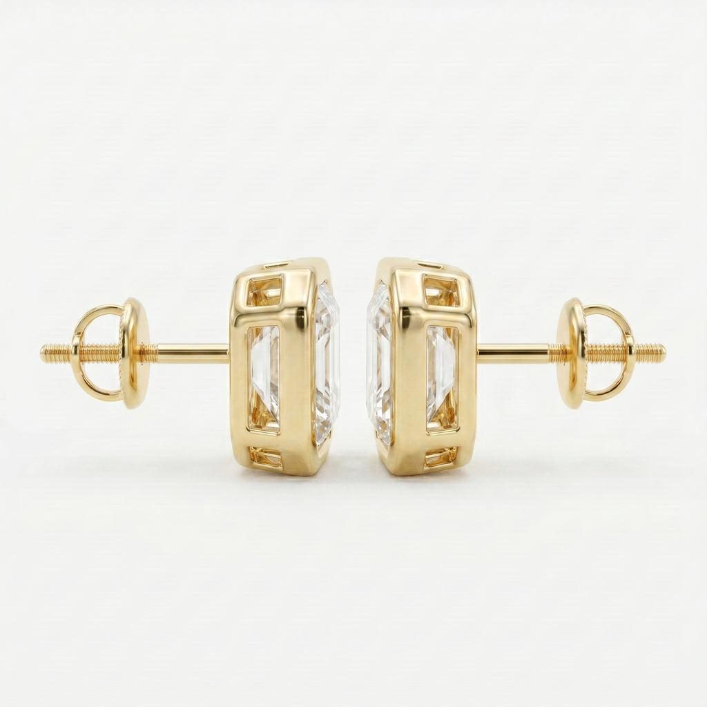 Gold earrings with clear gemstones on a white background