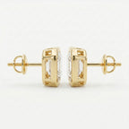 Gold earrings with clear gemstones on a white background