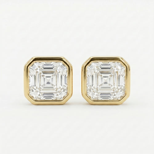 Gold earrings with Ascher-cut gemstones on a white background