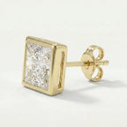 Gold earring with a clear gemstone on a light gray background