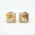 Close-up macro detail of geometric rose gold earrings with pavé diamonds and polished luxury finish