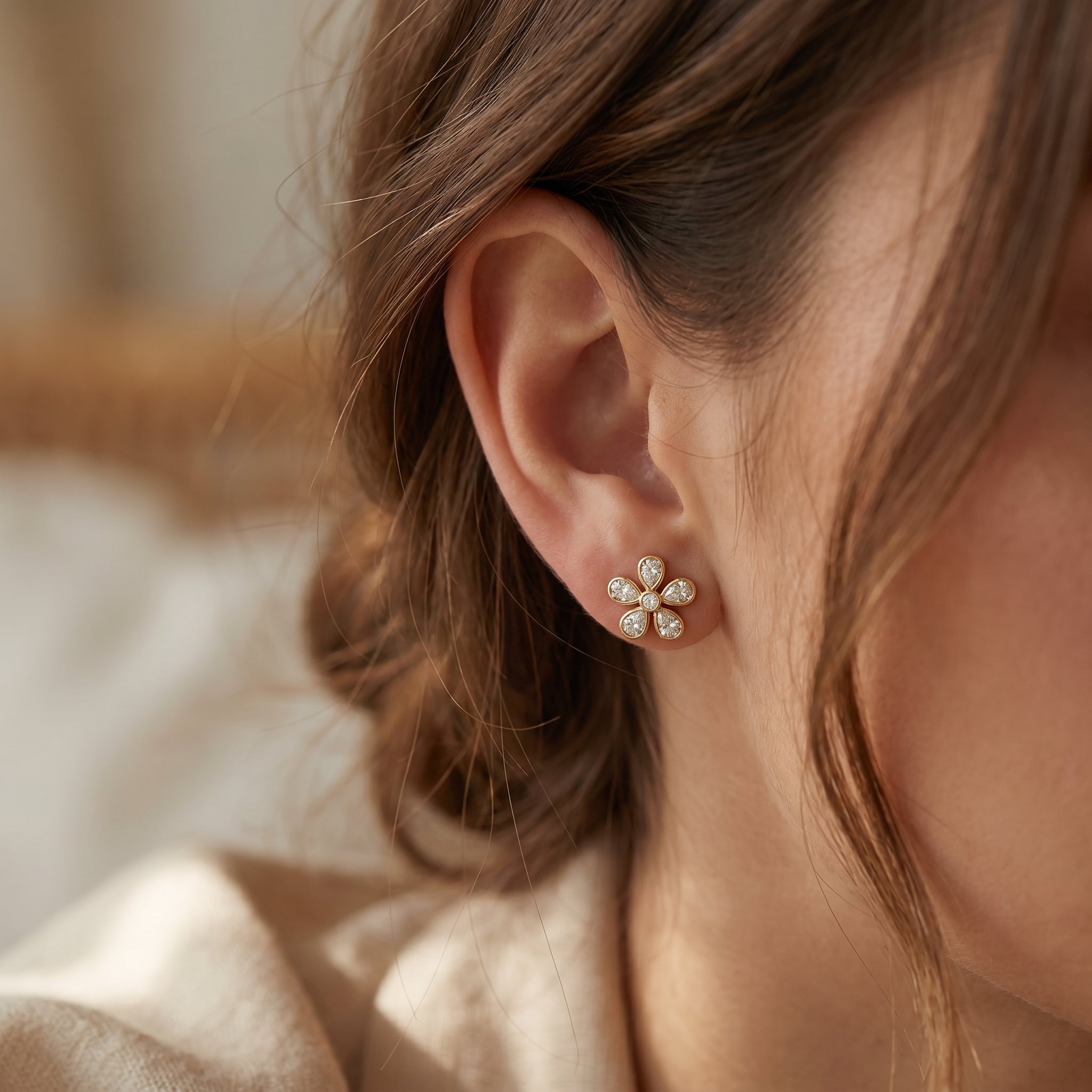 Side profile of diamond flower stud earrings showing secure post backing and polished rose gold setting
