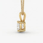 Gold pendant with a diamond on a white background