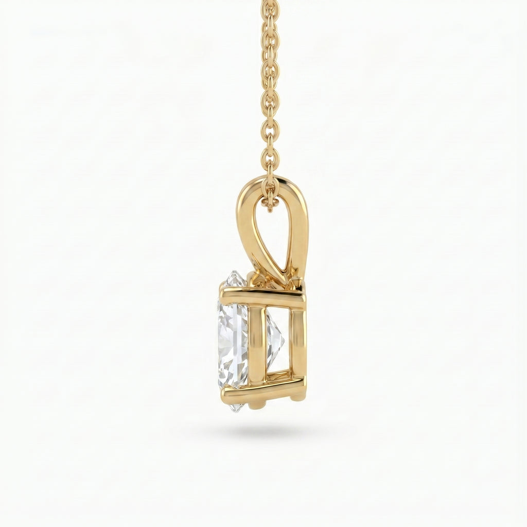 Gold pendant with a clear gemstone on a white background