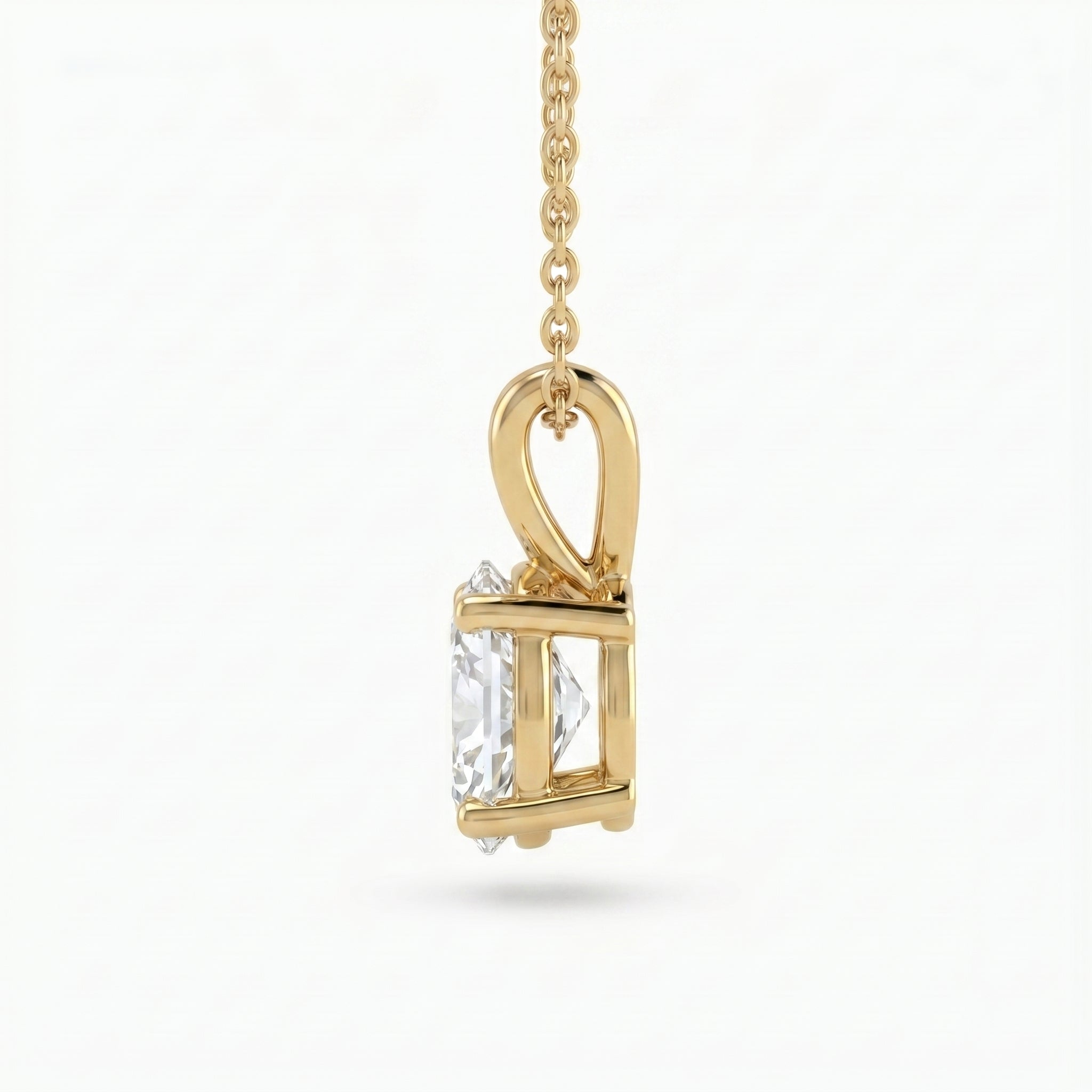 Gold pendant with a clear gemstone on a white background