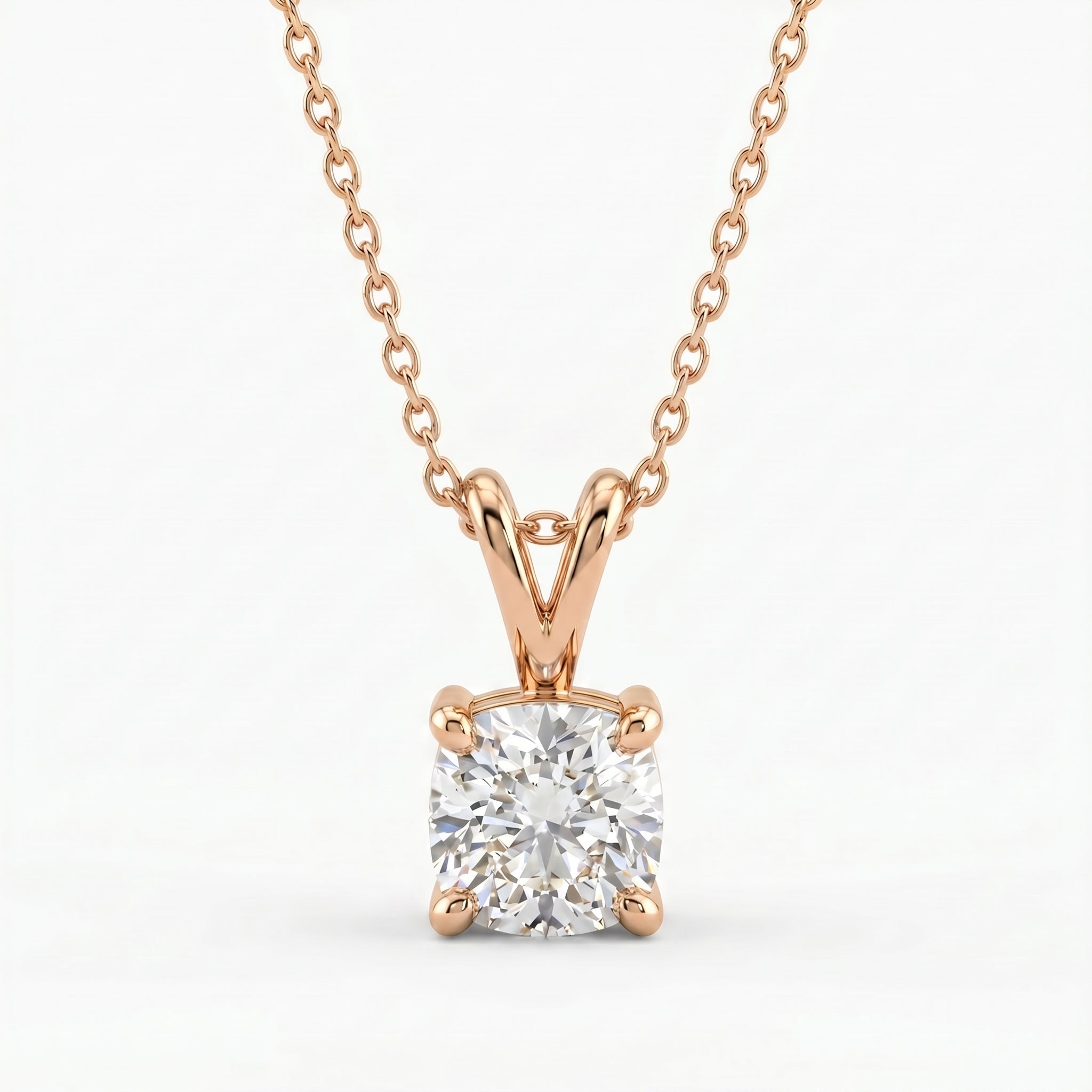 Rose gold necklace with a diamond pendant on a white background