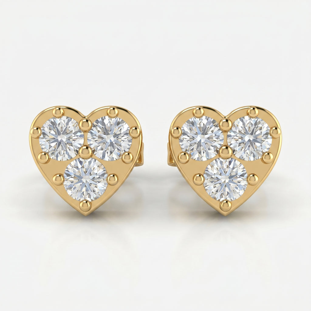 Heart-shaped yellow gold diamond stud earrings with three round brilliant diamonds on white background