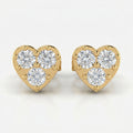Heart-shaped yellow gold diamond stud earrings with three round brilliant diamonds on white background