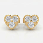 Heart-shaped yellow gold diamond stud earrings with three round brilliant diamonds on white background