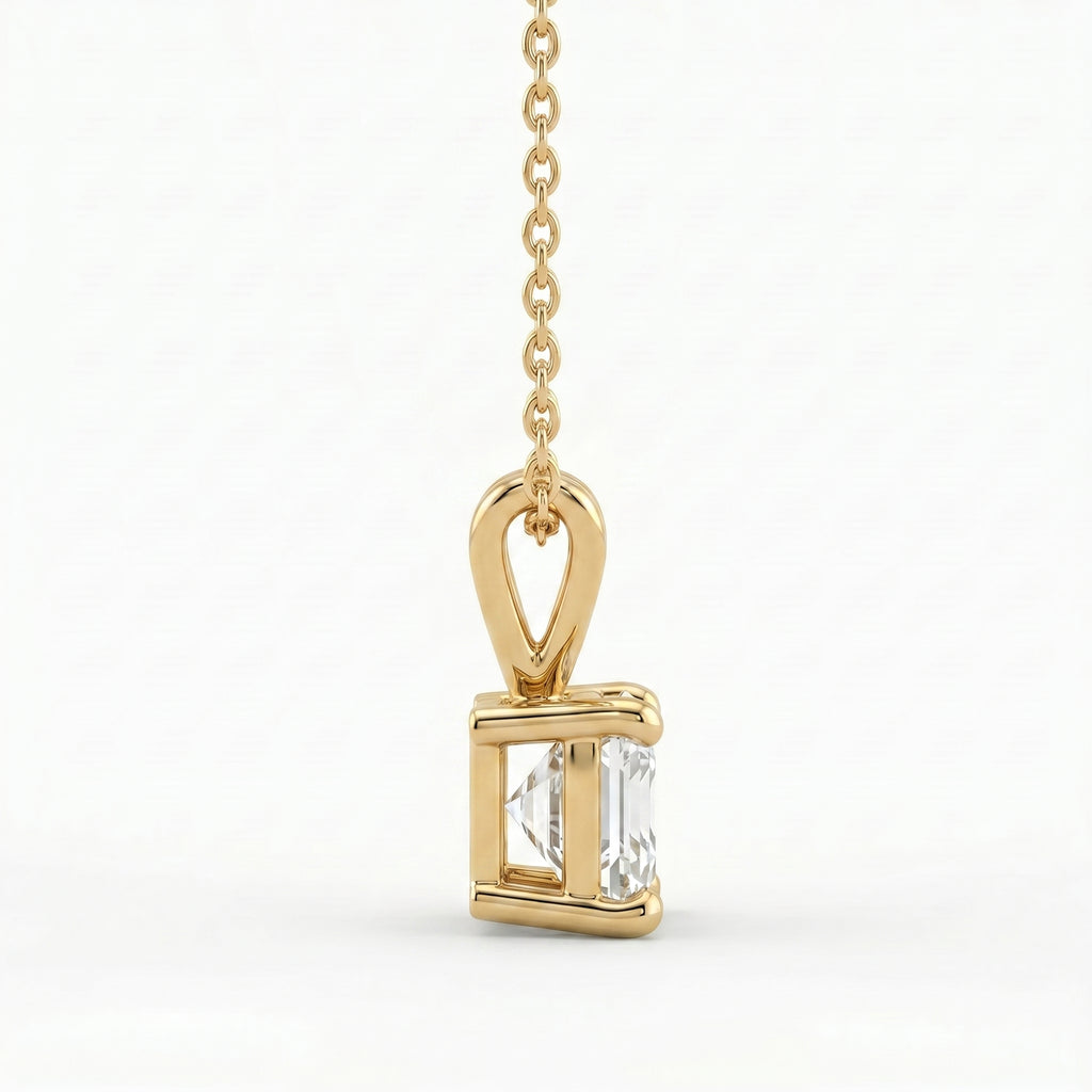 Gold pendant with a clear gemstone on a white background