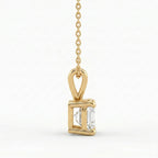 Gold pendant with a clear gemstone on a white background