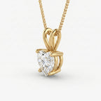 Gold necklace with a pear-shaped diamond pendant on a white background