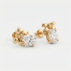  Yellow gold bow earrings with oval-cut diamonds shown in angled luxury studio product photography
